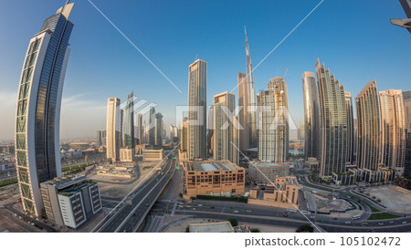 Aerial view of Dubai Downtown skyline with many towers day to night timelapse. Aerial view of Dubai Downtown skyline with many towers day to night timelapse. 105102472