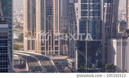 Top aerial view of busy road intersection and traffic junctions in Dubai city timelapse. 105102522