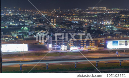 Aerial view to Dubai City Walk district night timelapse from above 105102551