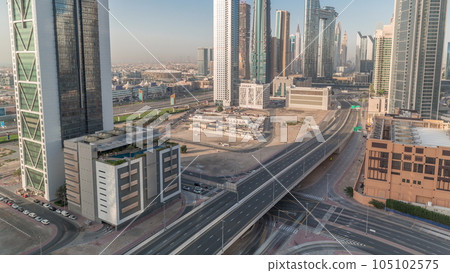 Many towers and skyscrapers with traffic on streets in Dubai Downtown and financial district timelapse. Many towers and skyscrapers with traffic on streets in Dubai Downtown and financial district timelapse. 105102575