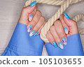 Manicure in the marine style.  Photos with beautiful well-groomed female nails. Selective focus. 105103655