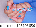 Manicure in the marine style.  Photos with beautiful well-groomed female nails. Selective focus. 105103656