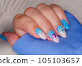 Manicure in the marine style.  Photos with beautiful well-groomed female nails. Selective focus. 105103657