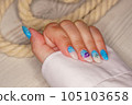 Manicure in the marine style.  Photos with beautiful well-groomed female nails. Selective focus. 105103658