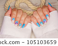 Manicure in the marine style.  Photos with beautiful well-groomed female nails. Selective focus. 105103659