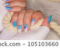 Manicure in the marine style.  Photos with beautiful well-groomed female nails. Selective focus. 105103660