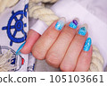 Manicure in the marine style.  Photos with beautiful well-groomed female nails. Selective focus. 105103661