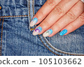 Manicure in the marine style.  Photos with beautiful well-groomed female nails. Selective focus. 105103662