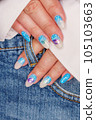 Manicure in the marine style.  Photos with beautiful well-groomed female nails. Selective focus. 105103663