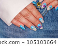 Manicure in the marine style.  Photos with beautiful well-groomed female nails. Selective focus. 105103664