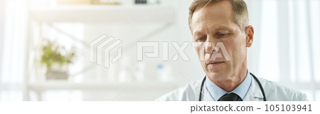 Handsome male doctor working in clinic or healthcare center 105103941