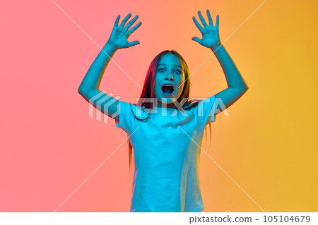 Surprised emotional school age girl, child wearing casual style clothes over neon light background. Concept of childhood, emotions, kids fashion Surprised emotional school age girl, child wearing casual style clothes over neon light background. Concept of childhood, emotions, kids fashion 105104679