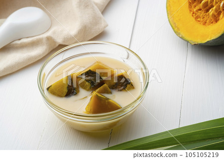 Coconut Milk Stewed Pumpkin,Thai dessert boiled sliced Pumpkin fruit in coconut milk with palm sugar in glass bowl 105105219