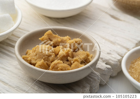 Natural Coconut palm sugar in white dish.Sweet condiment for Thai Traditional food. Natural Coconut palm sugar in white dish.Sweet condiment for Thai Traditional food. 105105223