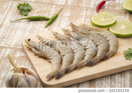 Fresh raw shrimp (Litopenaeus vannamei) on wooden plate.with copy space Fresh raw shrimp (Litopenaeus vannamei) on wooden plate.with copy space 105105239