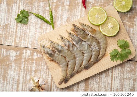 Fresh raw shrimp (Litopenaeus vannamei) on wooden plate.with copy space.Top view Fresh raw shrimp (Litopenaeus vannamei) on wooden plate.with copy space.Top view 105105240