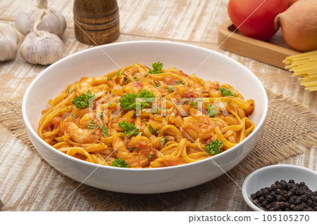 Spicy Shrimp Spaghetti with Tomato Sauce in white plate,linguine pasta Spicy Shrimp Spaghetti with Tomato Sauce in white plate,linguine pasta 105105270