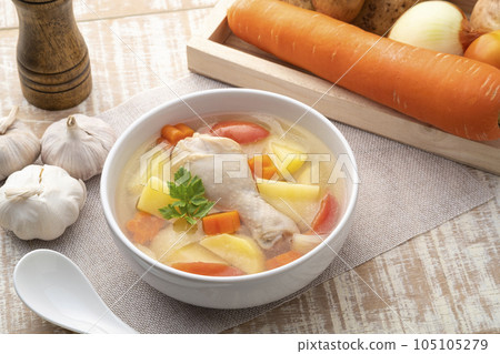 Clear chicken soup with potatoes carrot and onion in white bowl.Asian style food Clear chicken soup with potatoes carrot and onion in white bowl.Asian style food 105105279