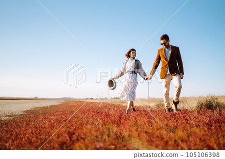 Stylish and loving couple enjoying each other outdoors. Enjoying time together. Springtime. Stylish and loving couple enjoying each other outdoors. Enjoying time together. Springtime. 105106398
