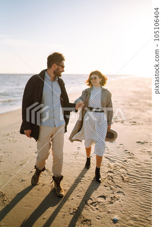 Stylish couple walking and hugging by the sea. Springtime. Relaxation, youth, love, lifestyle. Stylish couple walking and hugging by the sea. Springtime. Relaxation, youth, love, lifestyle. 105106404