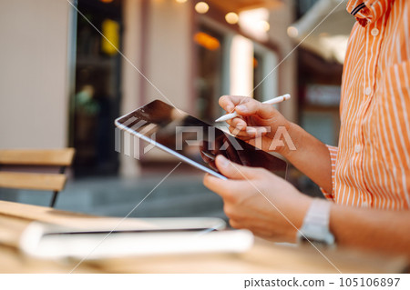 Male hand touching screen tablet close-up. Business, freelance, graphic concept. Male hand touching screen tablet close-up. Business, freelance, graphic concept. 105106897