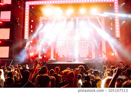 Use advanced mobile recording, fun concerts and beautiful lighting, Candid image of crowd at rock. Use advanced mobile recording, fun concerts and beautiful lighting, Candid image of crowd at rock. 105107513