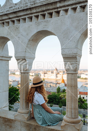 Back view. Tourist is looking at landscape of city from height. Travel in Europe. Back view. Tourist is looking at landscape of city from height. Travel in Europe. 105108170