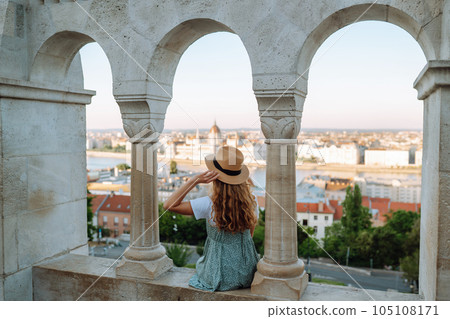 Back view. Tourist is looking at landscape of city from height. Travel in Europe. 105108171