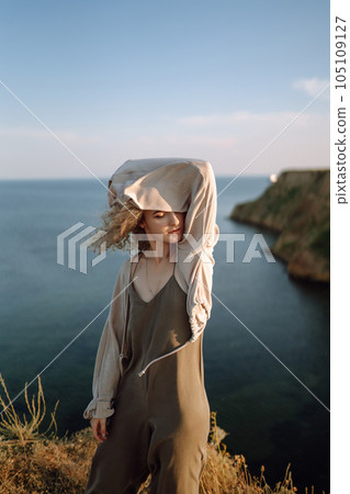 Young woman resting in nature. People, lifestyle, relaxation and vacations concept. Fashion. 105109127
