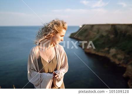 Young woman resting in nature. People, lifestyle, relaxation and vacations concept. Fashion. 105109128