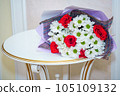 A beautiful luxurious bouquet of mixed flowers lies on the table. Wedding bouquet. Working as a florist in a flower shop 105109132