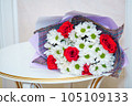 A beautiful luxurious bouquet of mixed flowers lies on the table. Wedding bouquet. Working as a florist in a flower shop 105109133