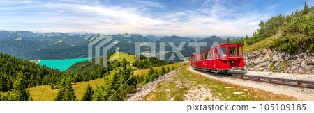 landscape with mountains and a lake Wolfgangsee and Schafberg cog railway train Schafbergbahn, Alps, Austria 105109185
