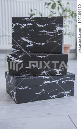 Blank black cardboard boxes for good and gifts. boxes for packaging goods from stores.festive packages 105109410