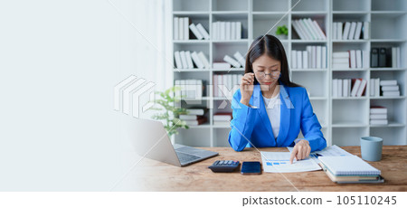 financial, Planning, Marketing and Accounting, portrait of Asian employee checking financial statements using documents and calculators at work.. financial, Planning, Marketing and Accounting, portrait of Asian employee checking financial statements using documents and calculators at work.. 105110245