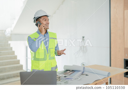 multi ethnic engineer brainstorming and measuring for cost estimating on blueprint and floor plan drawings about design architectural and engineering for houses and buildings. multi ethnic engineer brainstorming and measuring for cost estimating on blueprint and floor plan drawings about design architectural and engineering for houses and buildings. 105110330