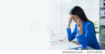 Portrait of business owner, woman using computer and financial statements Anxious expression on expanding the market to increase the ability to invest in business. Portrait of business owner, woman using computer and financial statements Anxious expression on expanding the market to increase the ability to invest in business. 105110456