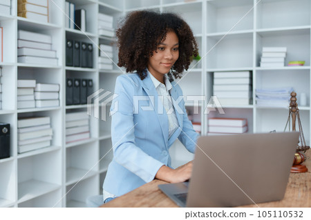 A young women African American lawyer lawsuit studying cases for clients in a law firm to fight against their parties in the courts. law and attorney concepts A young women African American lawyer lawsuit studying cases for clients in a law firm to fight against their parties in the courts. law and attorney concepts 105110532
