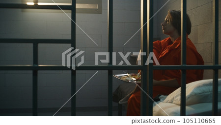 Prisoner gives dinner from food serving trolley to female criminal Prisoner gives dinner from food serving trolley to female criminal 105110665