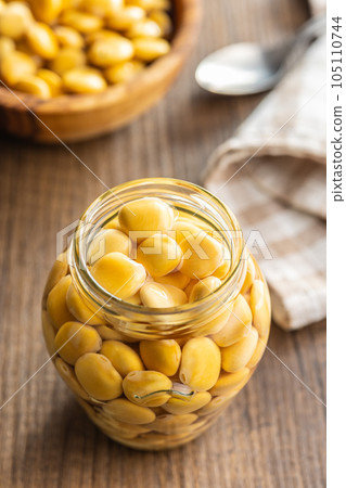 Lupini beans in brine. Pickled lupin in jar on kitchen table. 105110744