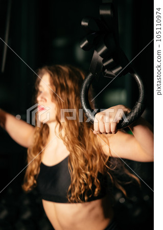 Athletic Beautiful Woman with TRX at gym. Athletic Beautiful Woman with TRX at gym. 105110974