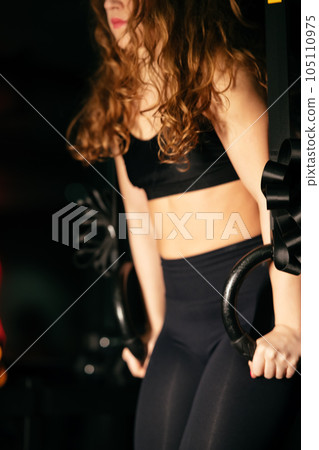 Athletic Beautiful Woman Does her cross fitness at gym Athletic Beautiful Woman Does her cross fitness at gym 105110975