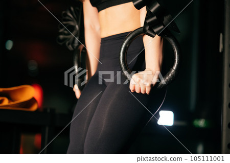 Athletic Beautiful Woman with TRX at gym. Athletic Beautiful Woman with TRX at gym. 105111001
