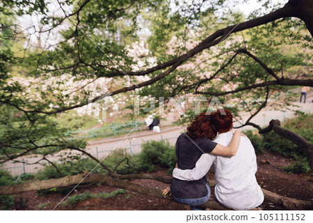 Young couple in love sitting and embracing to enjoy park view. Young couple in love sitting and embracing to enjoy park view. 105111152