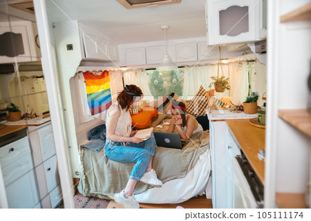 Portrait of a cute lesbian couple. Two girls spend time tenderly together in a camper trailer. Love and attitude. LGBT concept 105111174