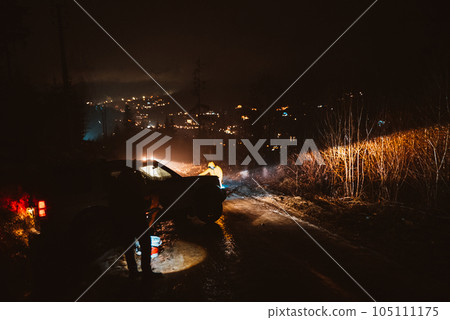 Man preparing bbq grill to cook on fire. Outside dark shot. Freeze moment of fire 105111175
