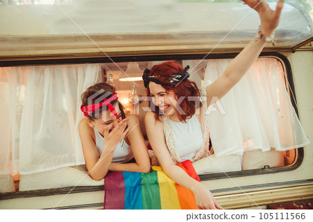 Portrait of a cute lesbian couple. Two girls spend time tenderly together in a camper trailer. Love and attitude. LGBT concept Portrait of a cute lesbian couple. Two girls spend time tenderly together in a camper trailer. Love and attitude. LGBT concept 105111566