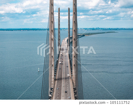 Panoramic aerial close up view of Oresund bridge over the Baltic sea between Malmo city in Sweden and Copenhagen in Denmark. 105111752