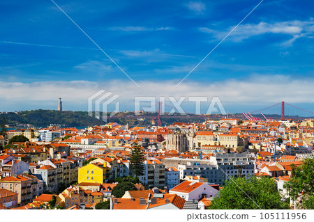 Lisbon famous view from Miradouro dos Barros tourist viewpoint over Alfama old city district, 25th of April Bridge and Christ the King statue. Lisbon, Portugal. With copyspace Lisbon famous view from Miradouro dos Barros tourist viewpoint over Alfama old city district, 25th of April Bridge and Christ the King statue. Lisbon, Portugal. With copyspace 105111956