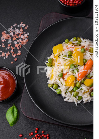 Delicious fresh white boiled rice with vegetables carrots, peppers and asparagus beans on a ceramic plate Delicious fresh white boiled rice with vegetables carrots, peppers and asparagus beans on a ceramic plate 105111974